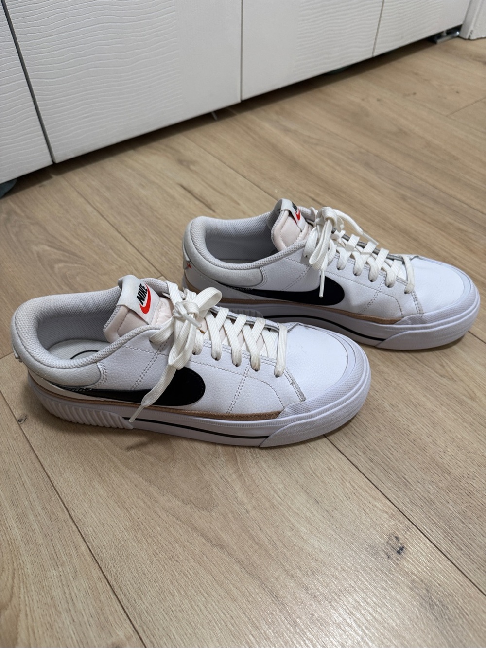 Nike Women’s White Sneakers with Black Swoosh and Tan Accent